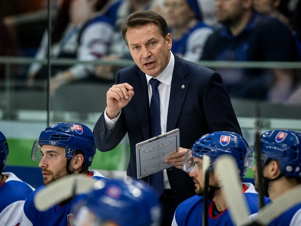 Ishockeytränare vid sargen ger instruktioner under en landskamp.
